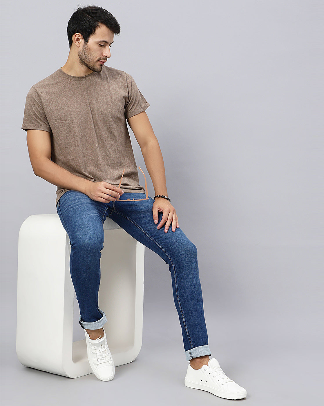 Full model view wearing True Colors of India®️ (TCI) Men’s Mid Blue Slim Fit Jeans, demonstrating the overall fit and style.