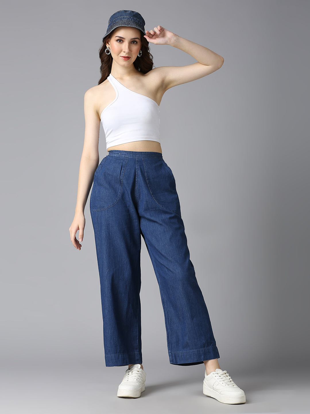 Model styling Cefalu Women's Blue Denim Palazzo Pants with a Crop Top & Bucket Hat - Trendy Casual Look