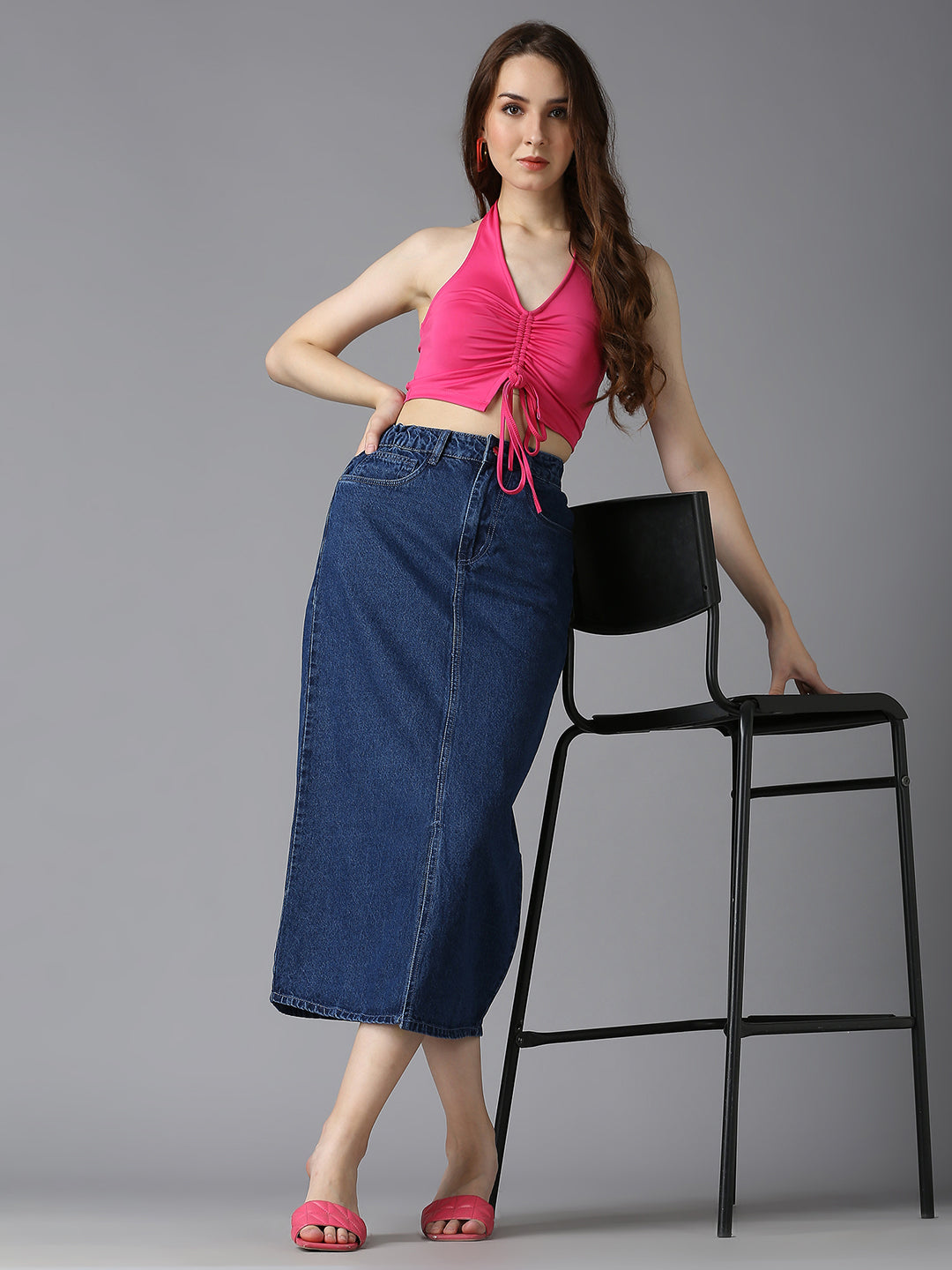 Model styling Cefalu Dark Blue Denim Midi Skirt with a Pink Crop Top & Heels - Trendy Fashion Look