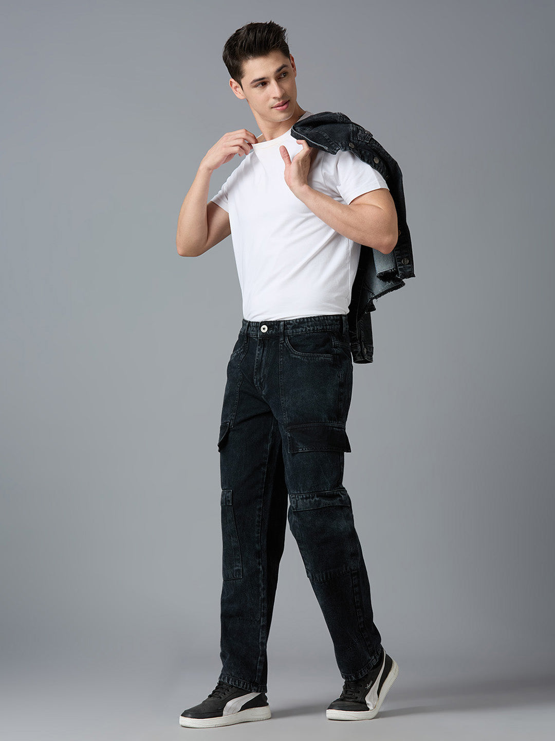 Model styling TCI Men's Black Denim Cargo Pants with a White T-Shirt & Sneakers - Trendy Streetwear Look