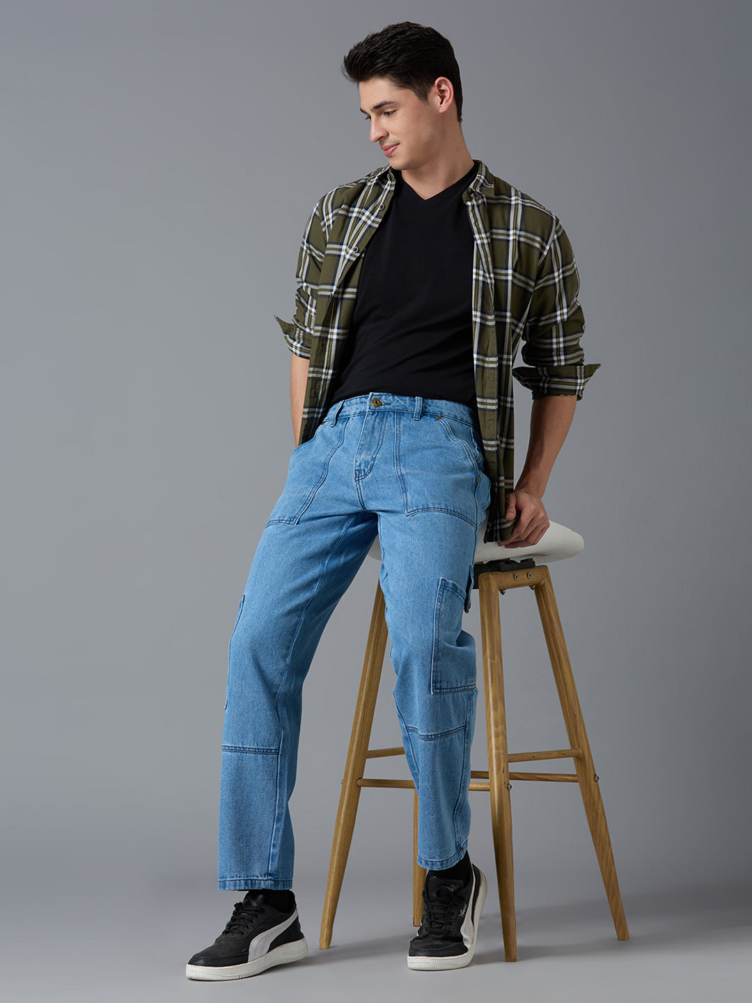 Model styling TCI Men's Light Blue Denim Cargo Pants with a Black T-Shirt & Sneakers - Urban Streetwear Look