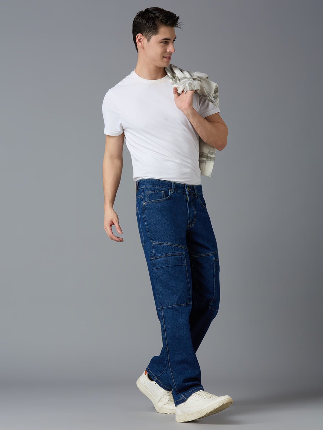 Model styling TCI Men's Mid Blue Denim Cargo Pants with a White T-Shirt & Sneakers - Trendy Streetwear Look