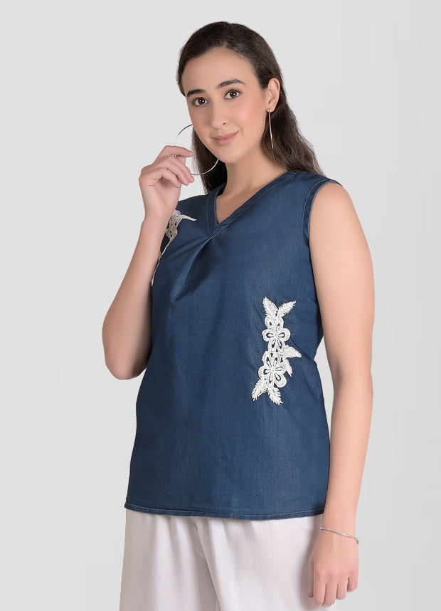 Close-up of V-neck and front patchwork detail on Cefalu Women’s Blue Denim Top.
