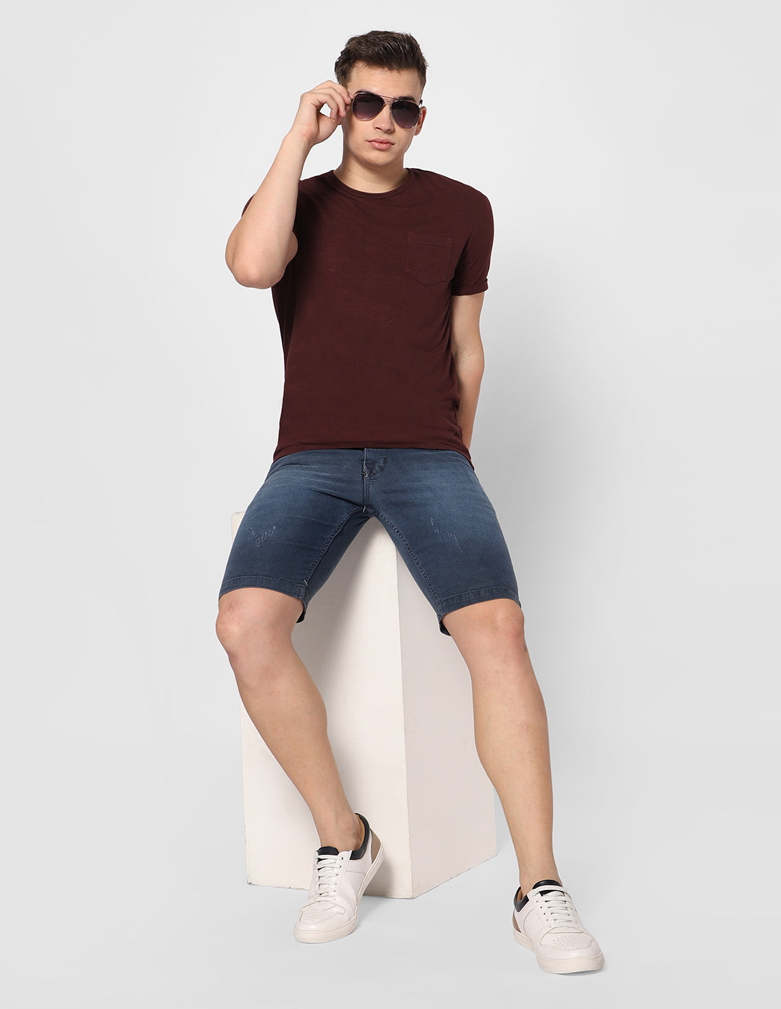 Model wearing TCI Men's Greyish Blue Denim Shorts, showcasing the fit and style in a casual setting.