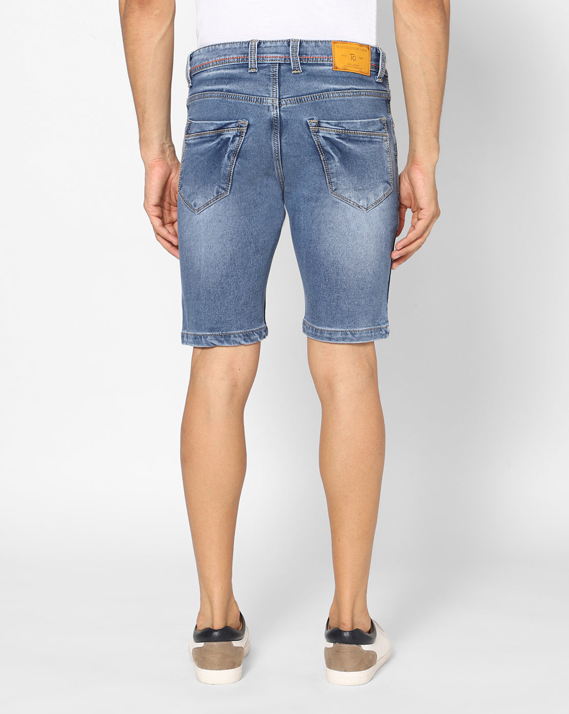 Back view of TCI Men’s Blue Denim Shorts, highlighting the design of the back pockets and slim fit.