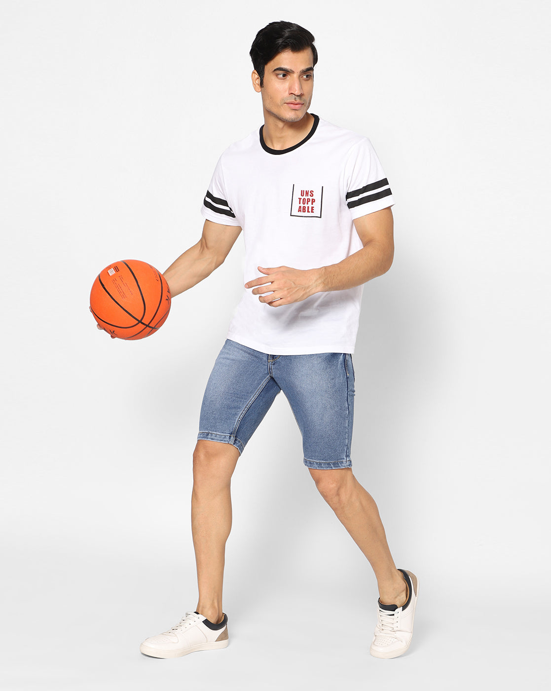 Model in a sport pose wearing TCI Men’s Blue Denim Shorts, showcasing the flexibility and fit of the shorts during active movement.