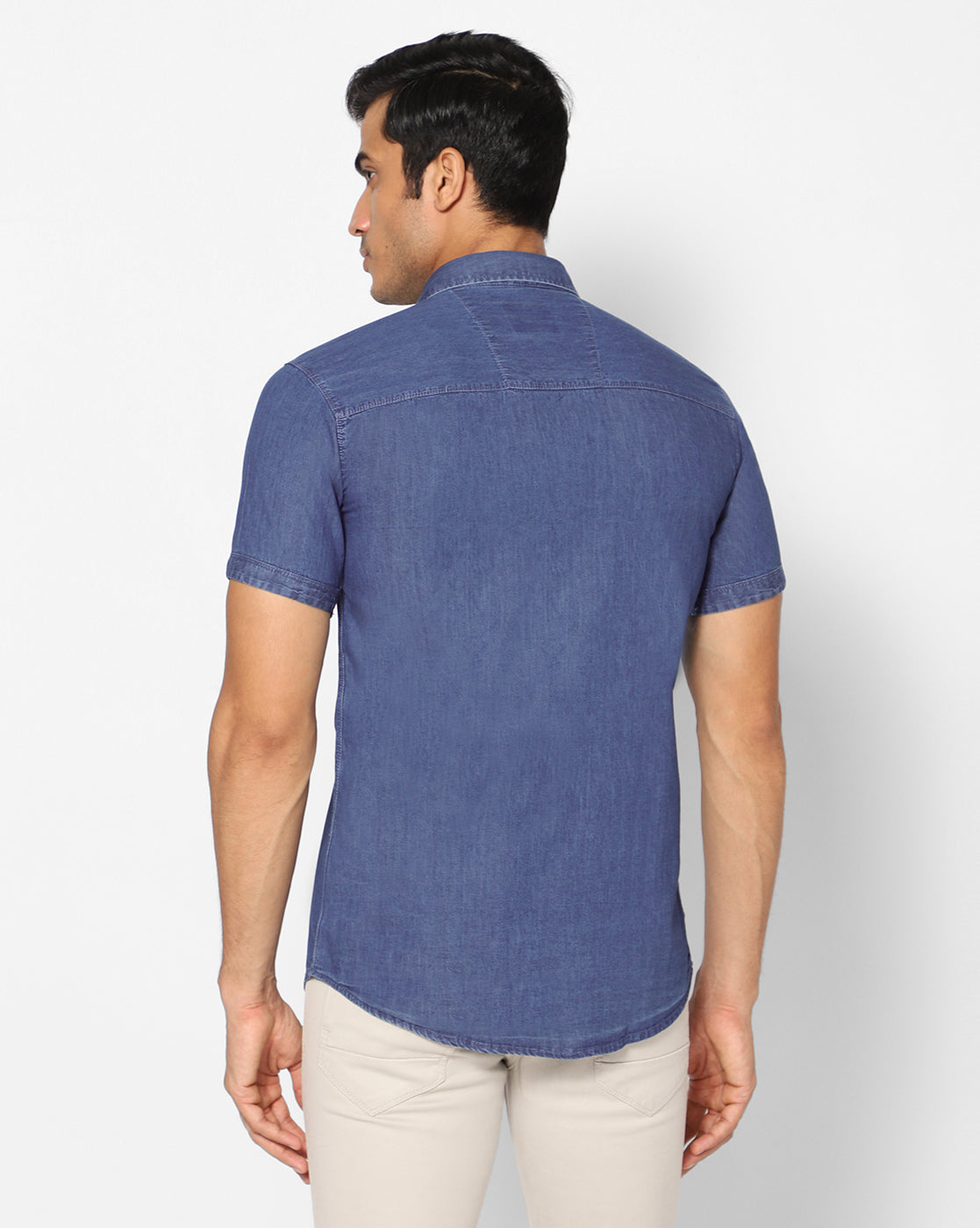 Back view of the TCI Men’s mid blue cotton denim shirt, showing the plain design and regular fit.