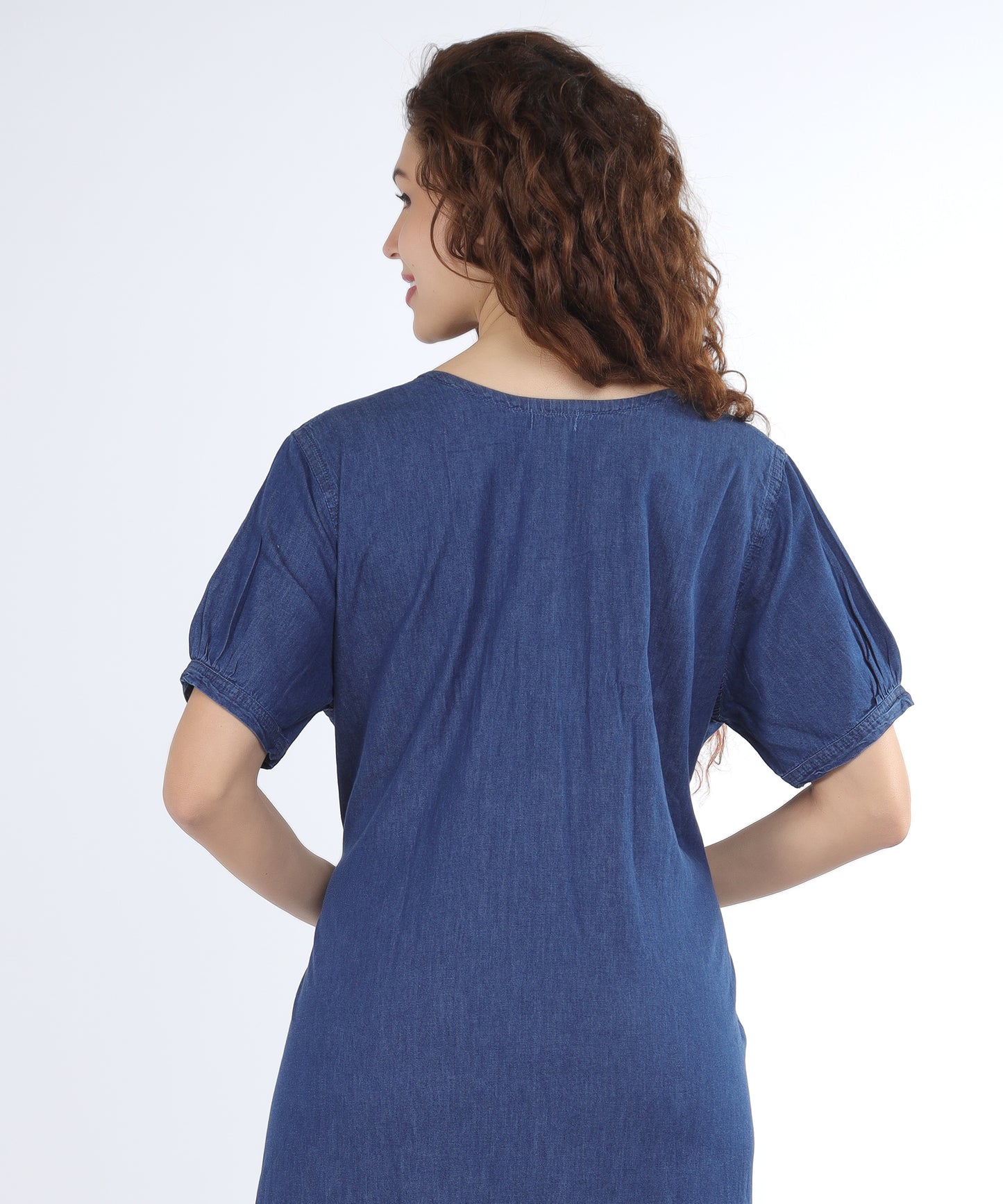 Back view of the Cefalu Women’s Denim Gown in blue, showing its unique design and flattering fit.