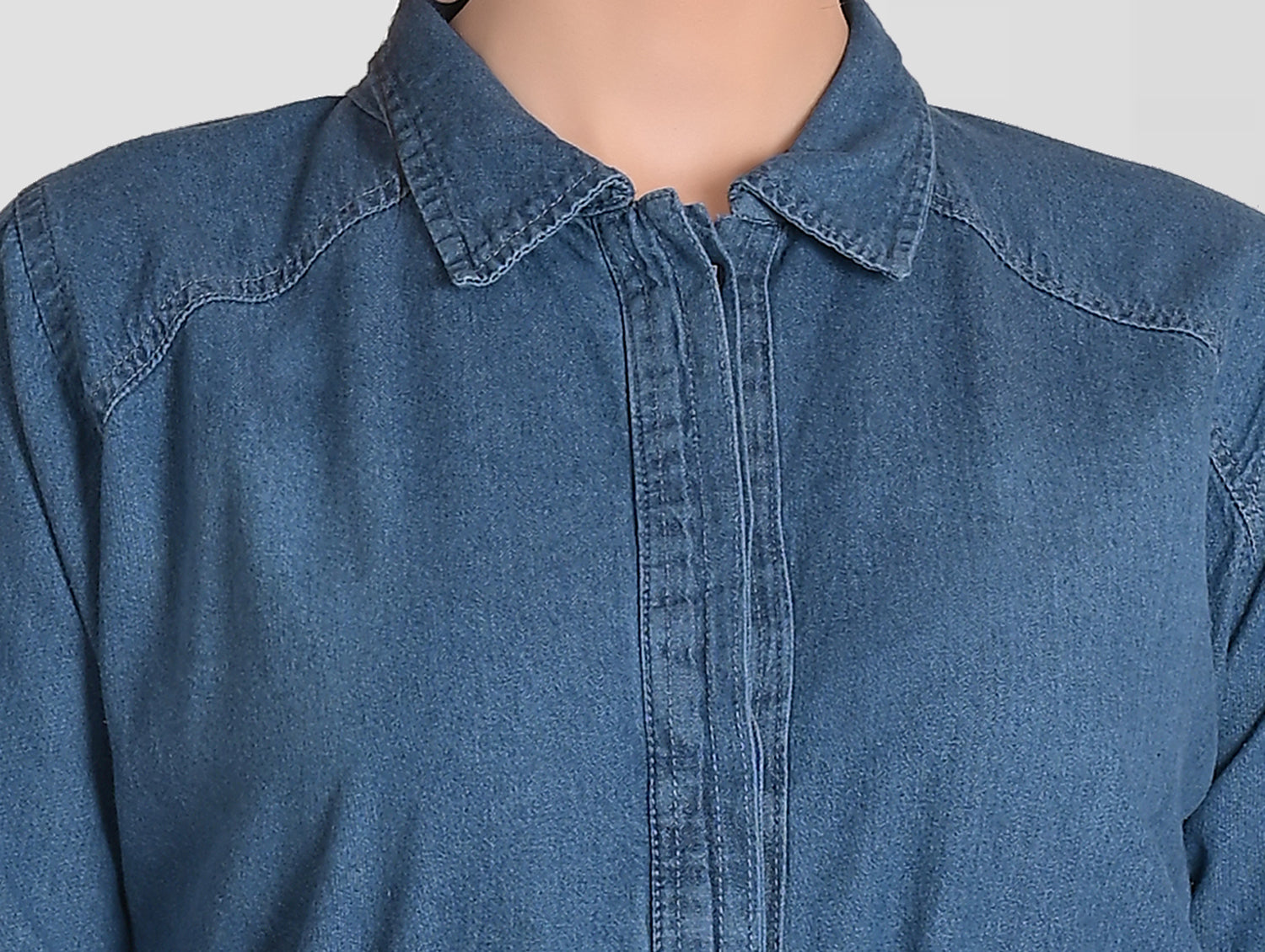 Close-up of the soft denim cotton fabric of Women’s Blue Denim Shirt Dress, highlighting the quality and texture.