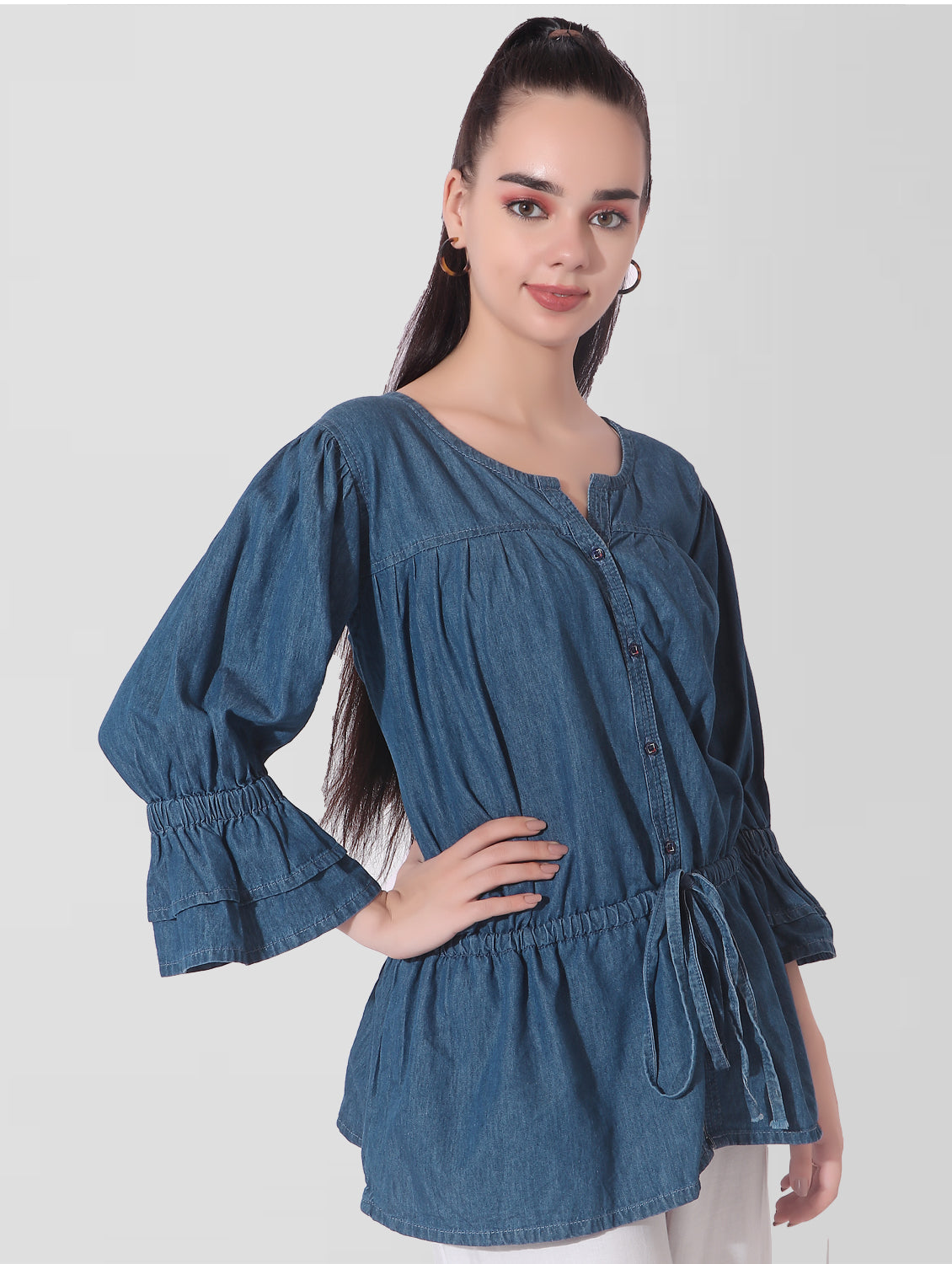 Side view of Casual Women’s Blue Denim Top highlighting the bell sleeves and waist fit extension Dori.