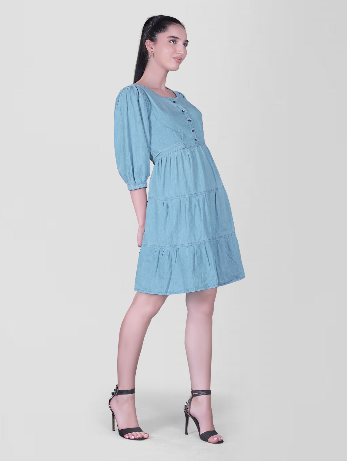 Side view of Cefalu Women’s Light Blue Denim Dress showing fit and flare silhouette and 3/4 puff sleeves.