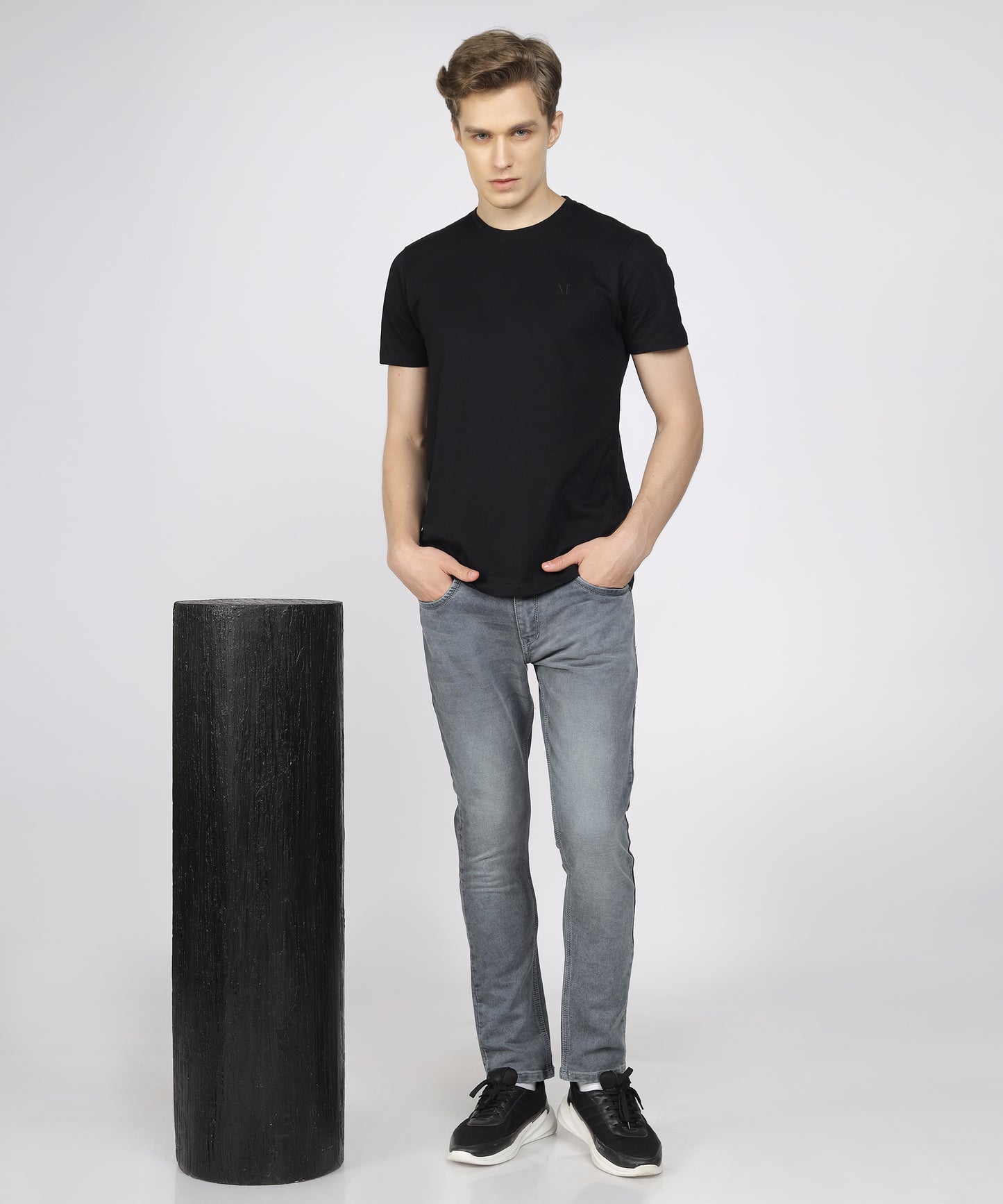 Model showcasing TCI Men’s Slim Fit Stretchable Jeans in Sulphar Grey, styled for a casual look.