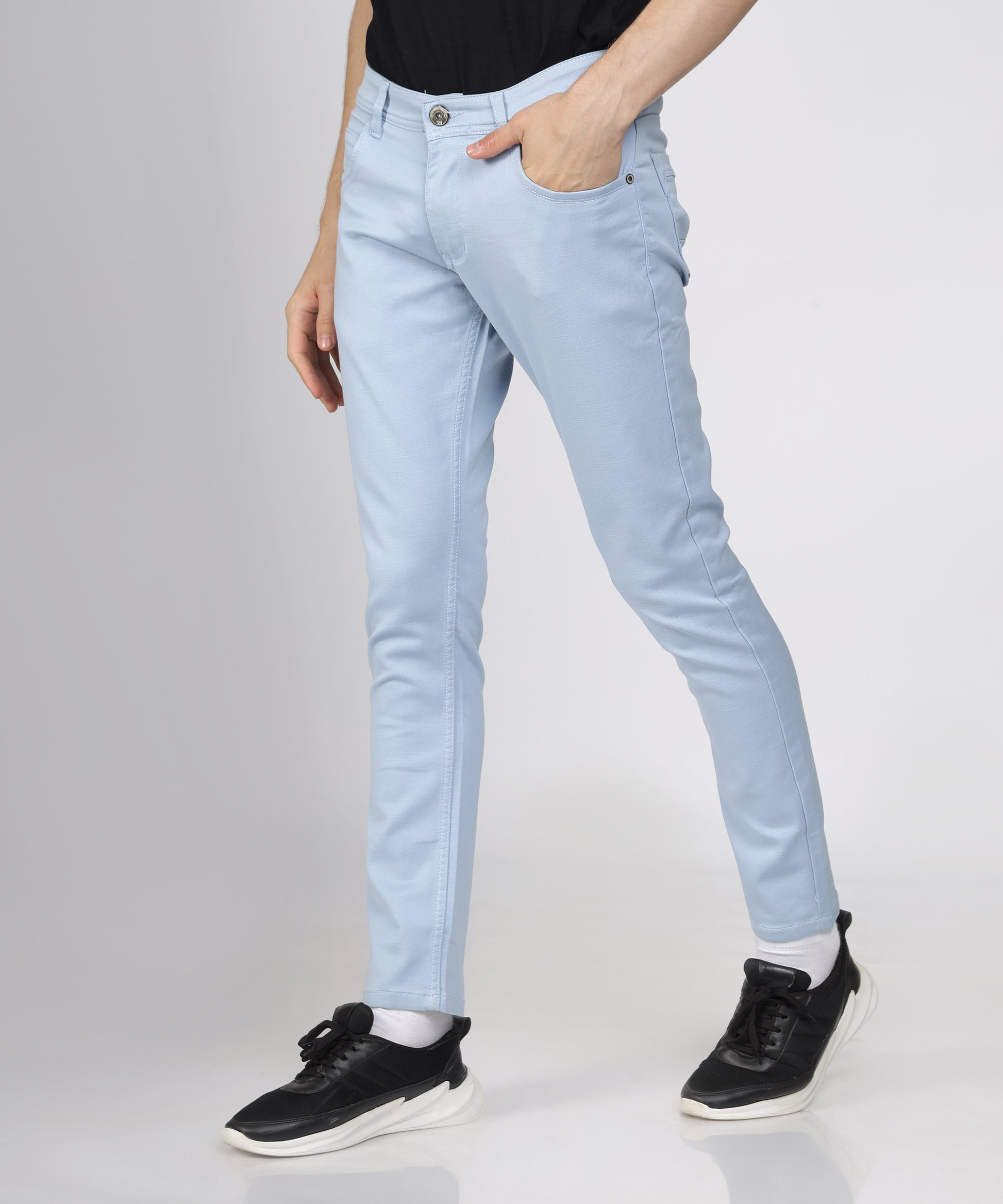 Detail of the button closure on TCI Men’s Light Blue Trousers.