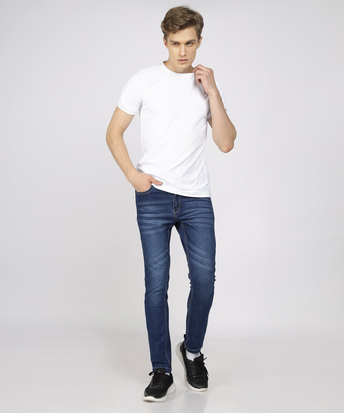 Model wearing TCI Men’s Mid Blue Jeans styled for casual wear.
