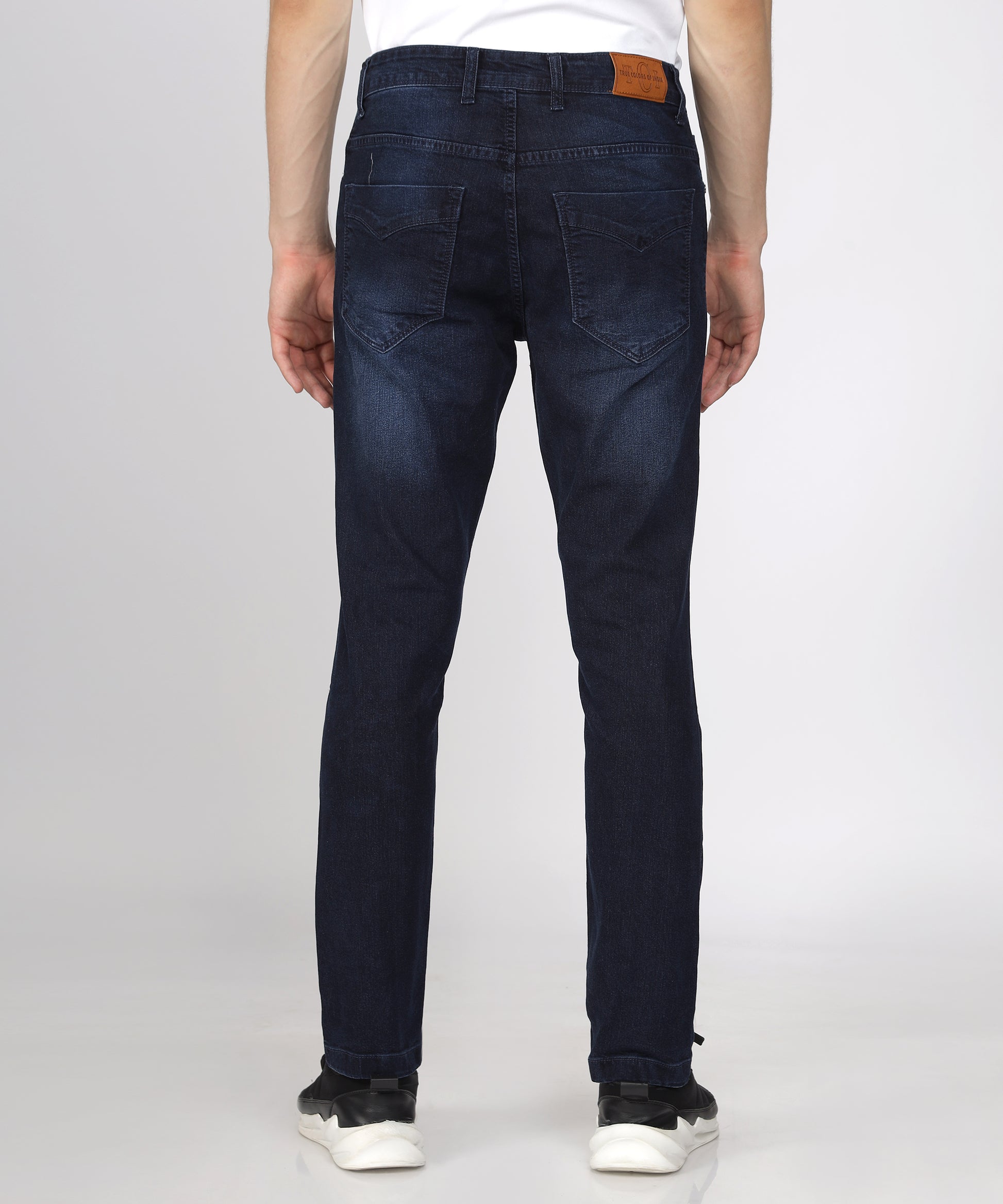 back view of Texture of TCI Men’s Ink Blue Slim Fit Jeans highlighting stretchability.