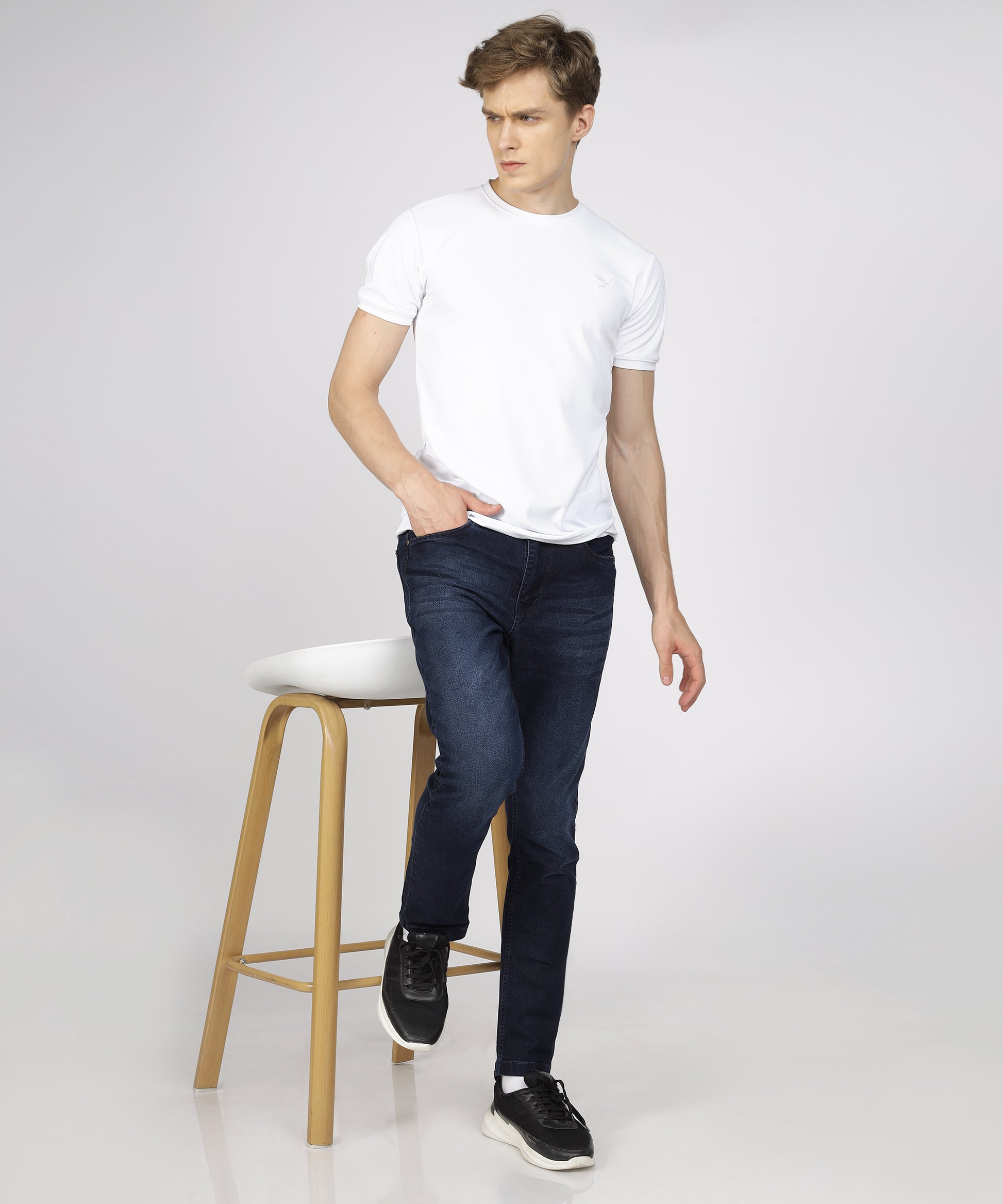 Model showcasing TCI Men’s Ink Blue Jeans styled for casual wear.
