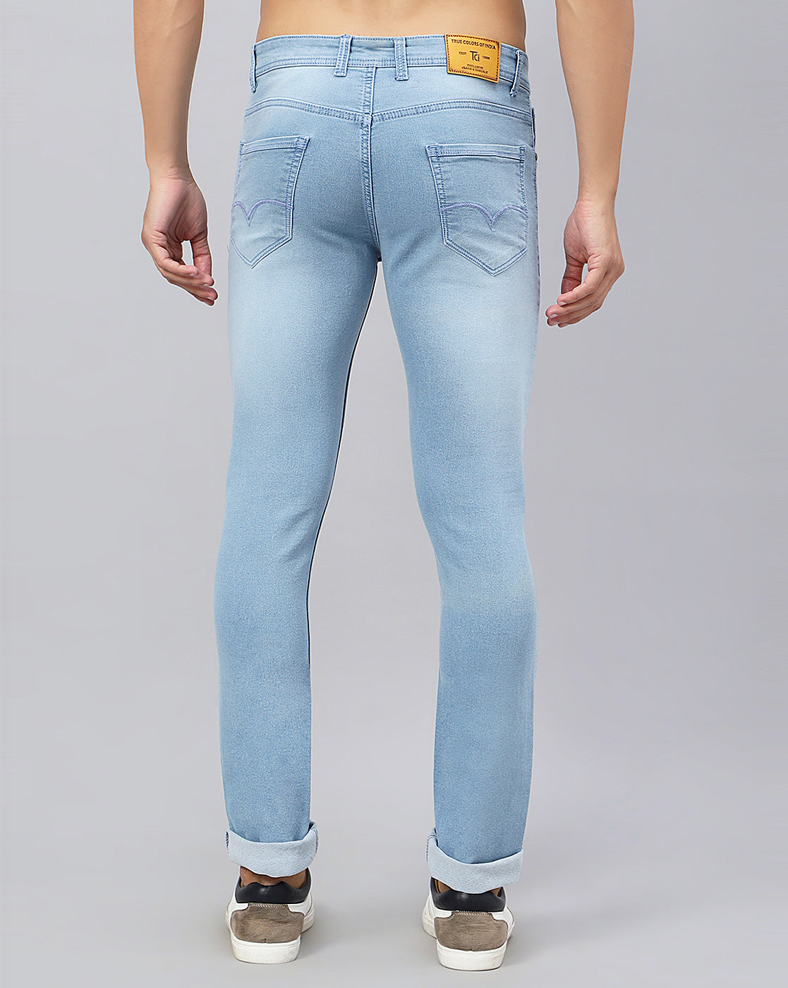 Back view of True Colors of India®️ light blue jeans for men, highlighting the welt pockets and overall fit.