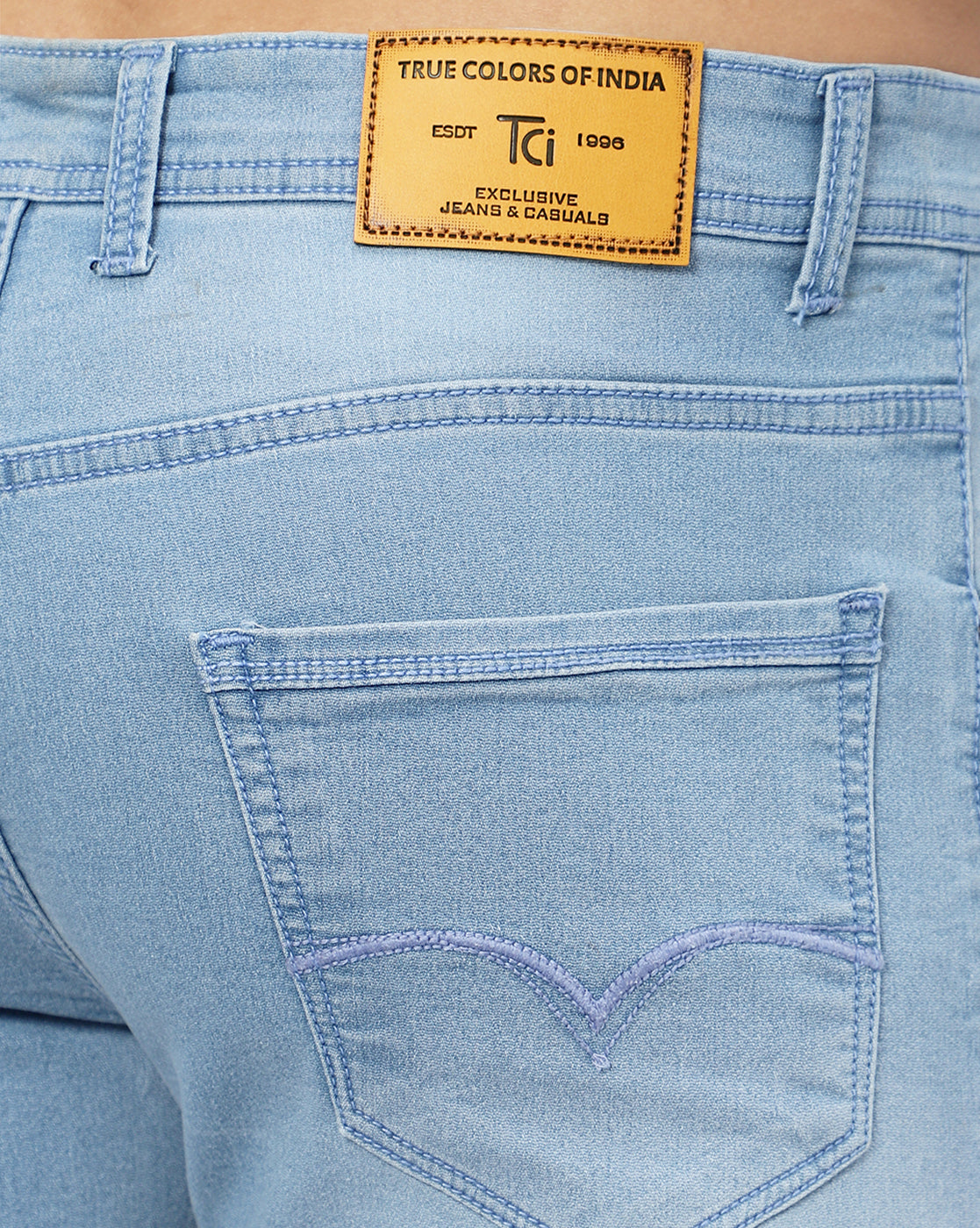 Close-up of the highly stretchable and durable denim fabric of True Colors of India®️ light blue jeans for men.