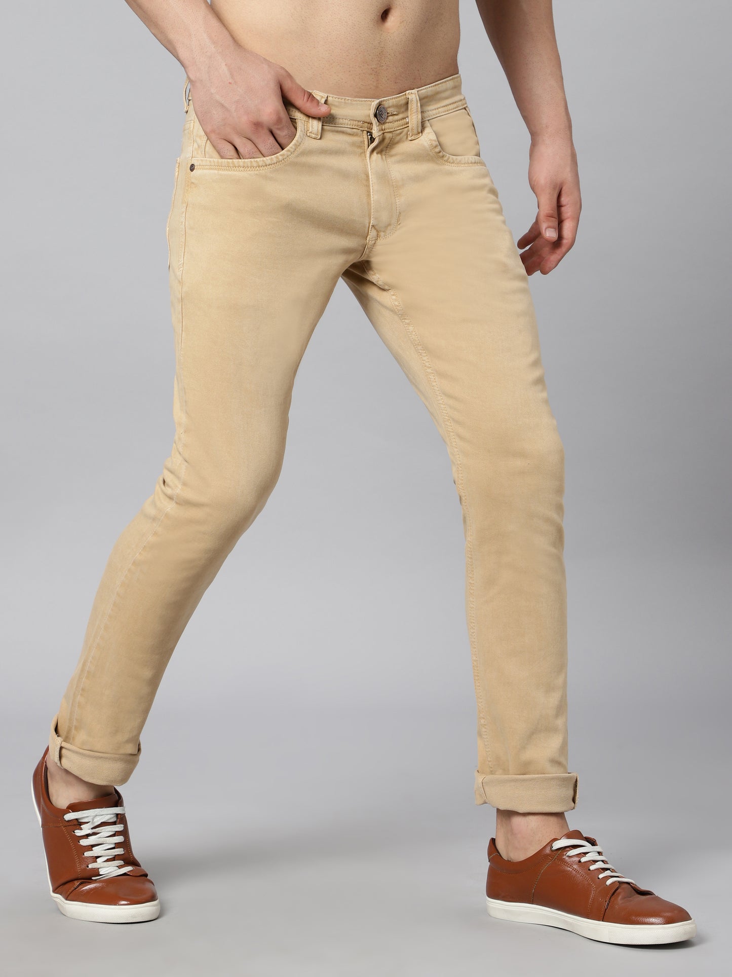 Close-up of the waistband on TCI Men’s Beige (Fawn) Jeans, highlighting the mid-rise fit and stitching.