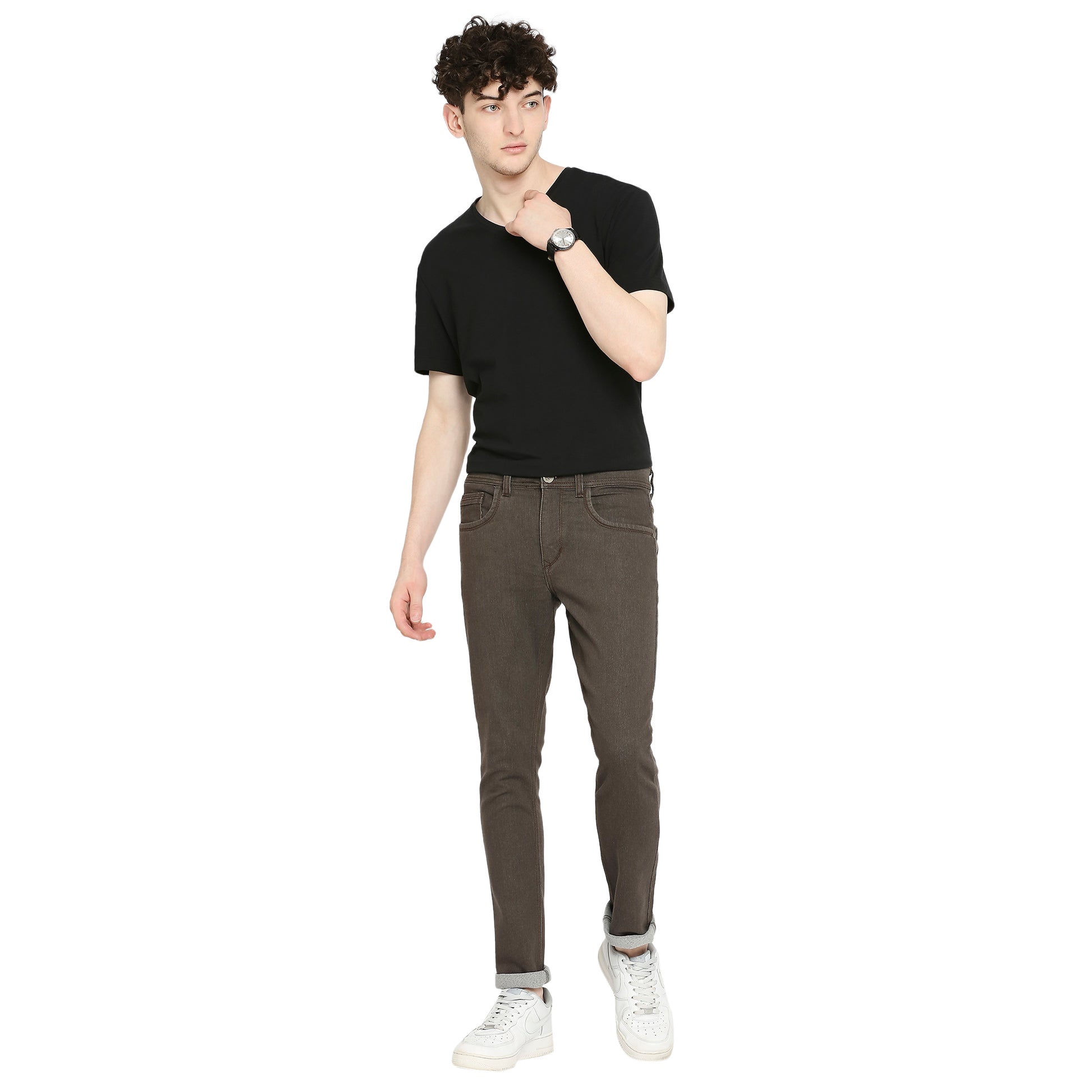 TCI Men’s Dark Brown Slim Fit Jeans worn by a model, showcasing the slim fit and mid-rise design. The jeans are paired with a casual shirt, demonstrating their stylish and versatile look.