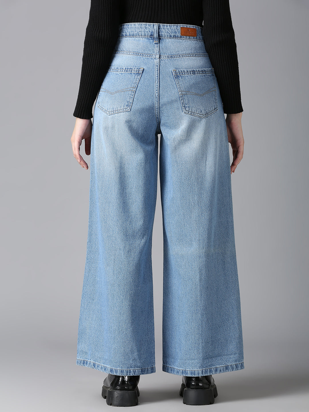 Back view of women’s CEFALU high-waist wide-leg denim jeans in a light blue wash.