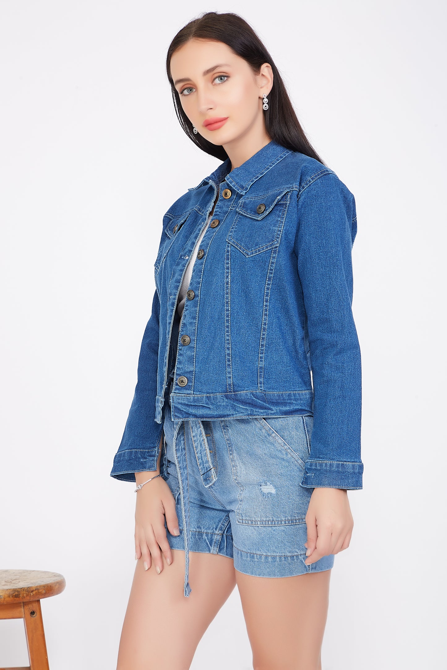 Left side view of a model in Cefalu®️ Solid Blue Denim Jacket for Women, highlighting the full sleeves and stand collar