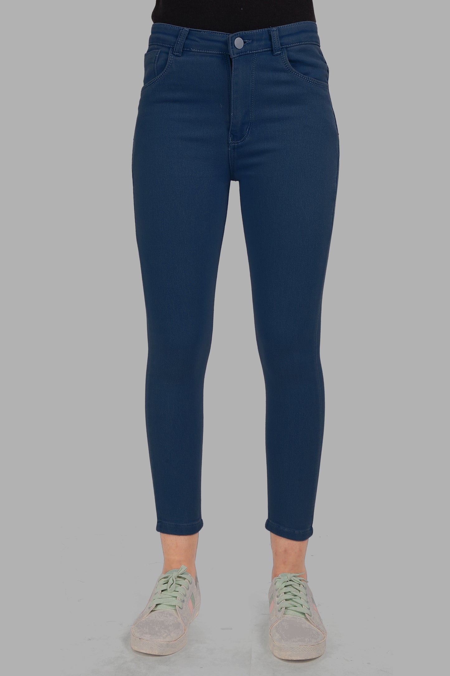 Front view of Cefalu Women’s Electric Blue Skinny Jeans, showcasing the sleek design and vibrant color. The jeans feature a mid-rise waist and a form-fitting silhouette.