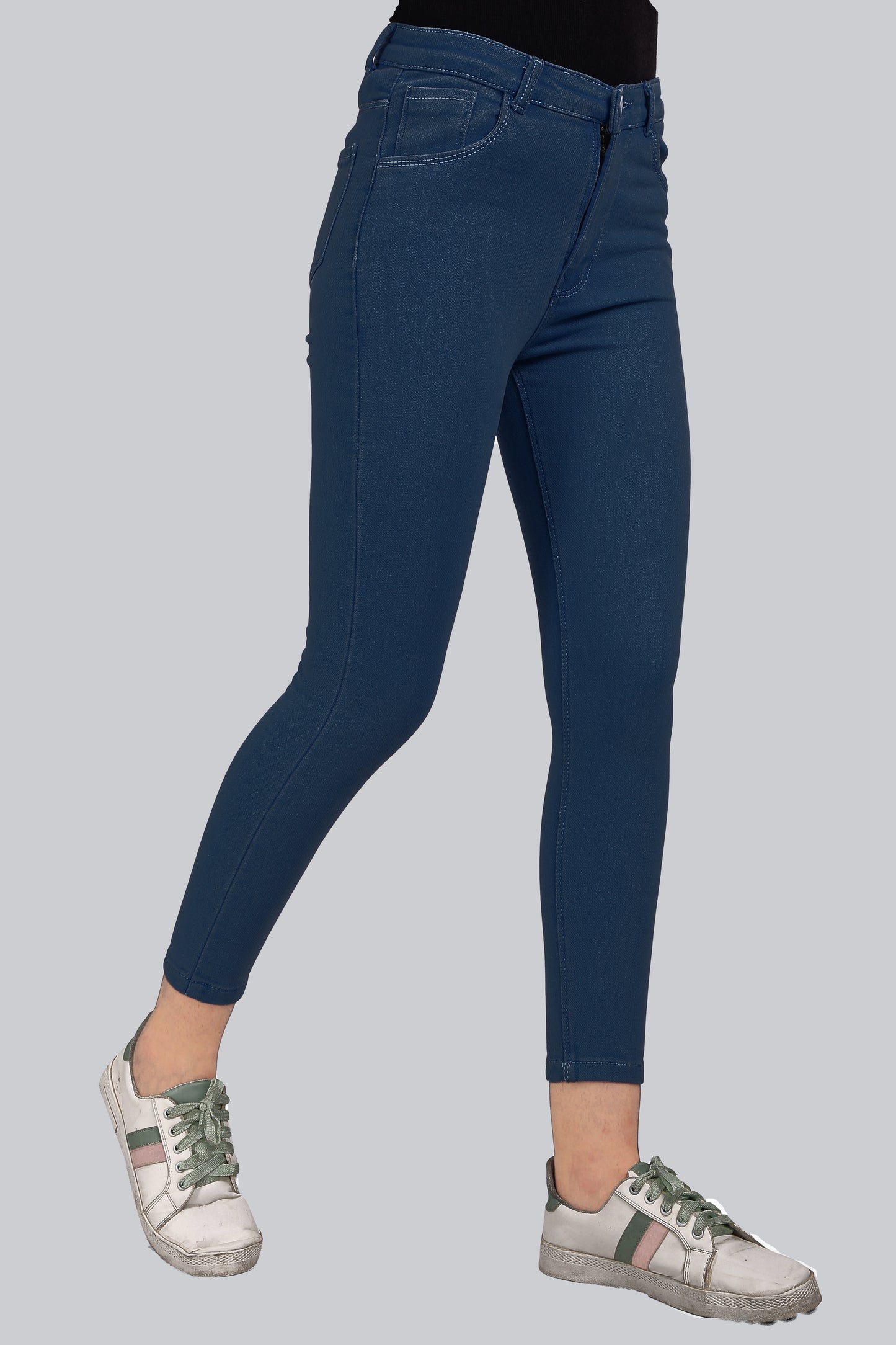 Side view of Cefalu Women’s Electric Blue Skinny Jeans, displaying the skinny fit and contouring design. The vibrant color and clean lines of the jeans are emphasized.