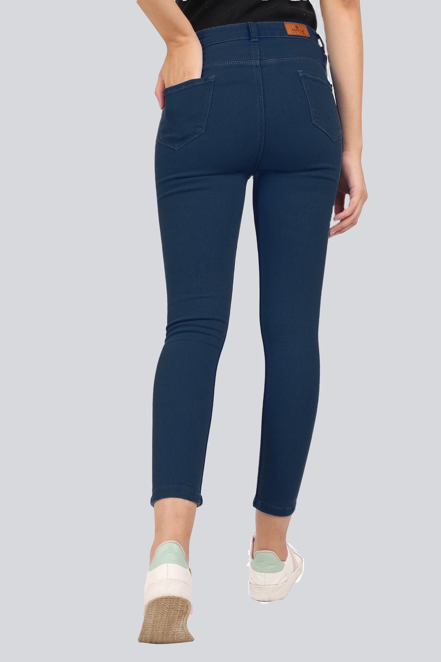 Back view of Cefalu Women’s Electric Blue Skinny Jeans, highlighting the flattering fit and smooth finish. The mid-rise waist and tailored design are visible.