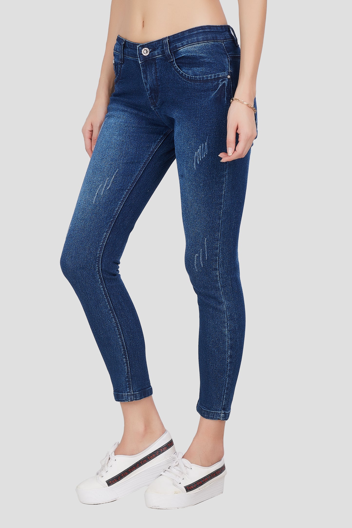 Left side view of Cefalu®️ Women’s Mid Blue Skinny Fit Jeans, emphasizing the skinny fit and light fade wash.