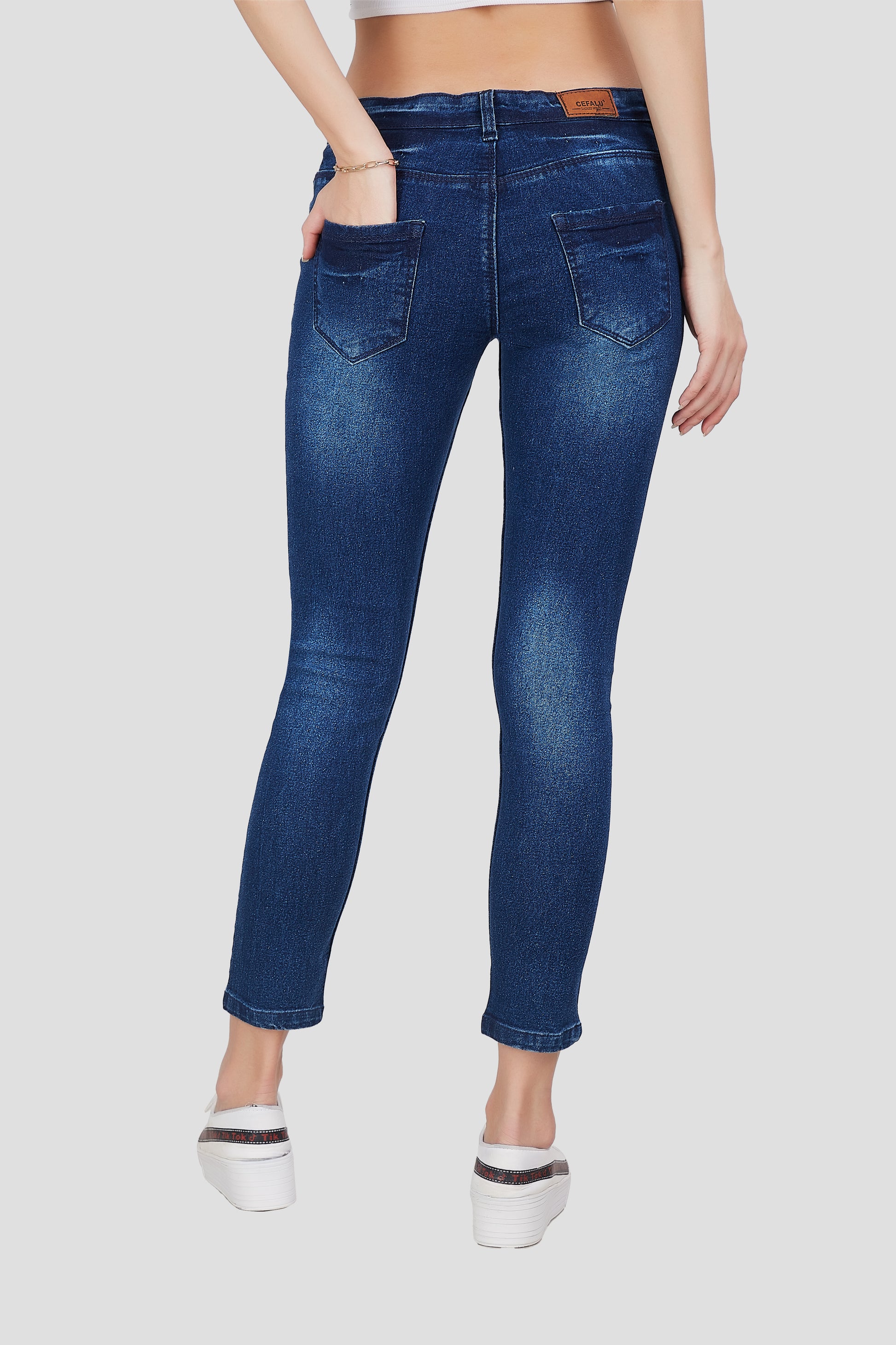 Back view of Cefalu®️ Women’s Mid Blue Skinny Fit Jeans, featuring the mid-rise fit and overall design.