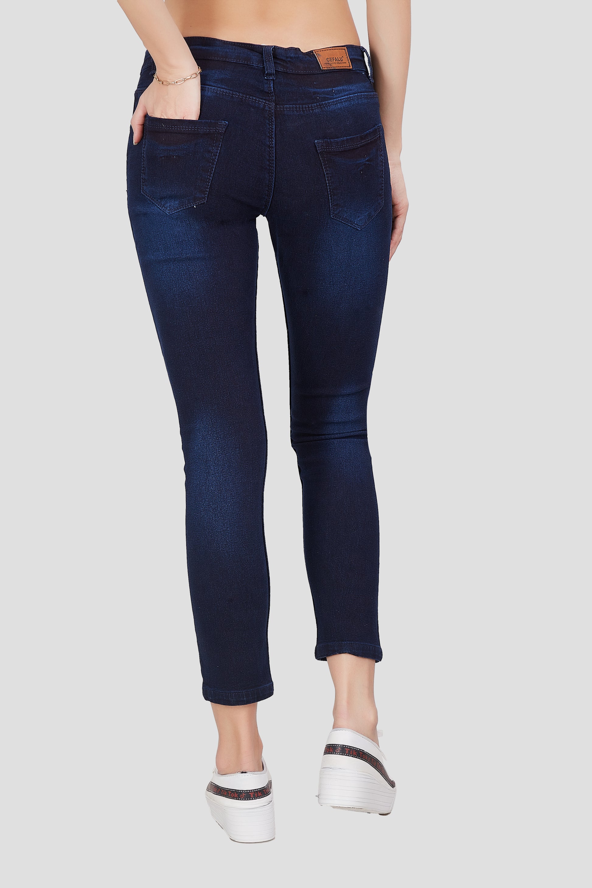 Back view of Cefalu®️ Women’s Dark Blue Skinny Fit Jeans, featuring the mid-rise fit and overall design.