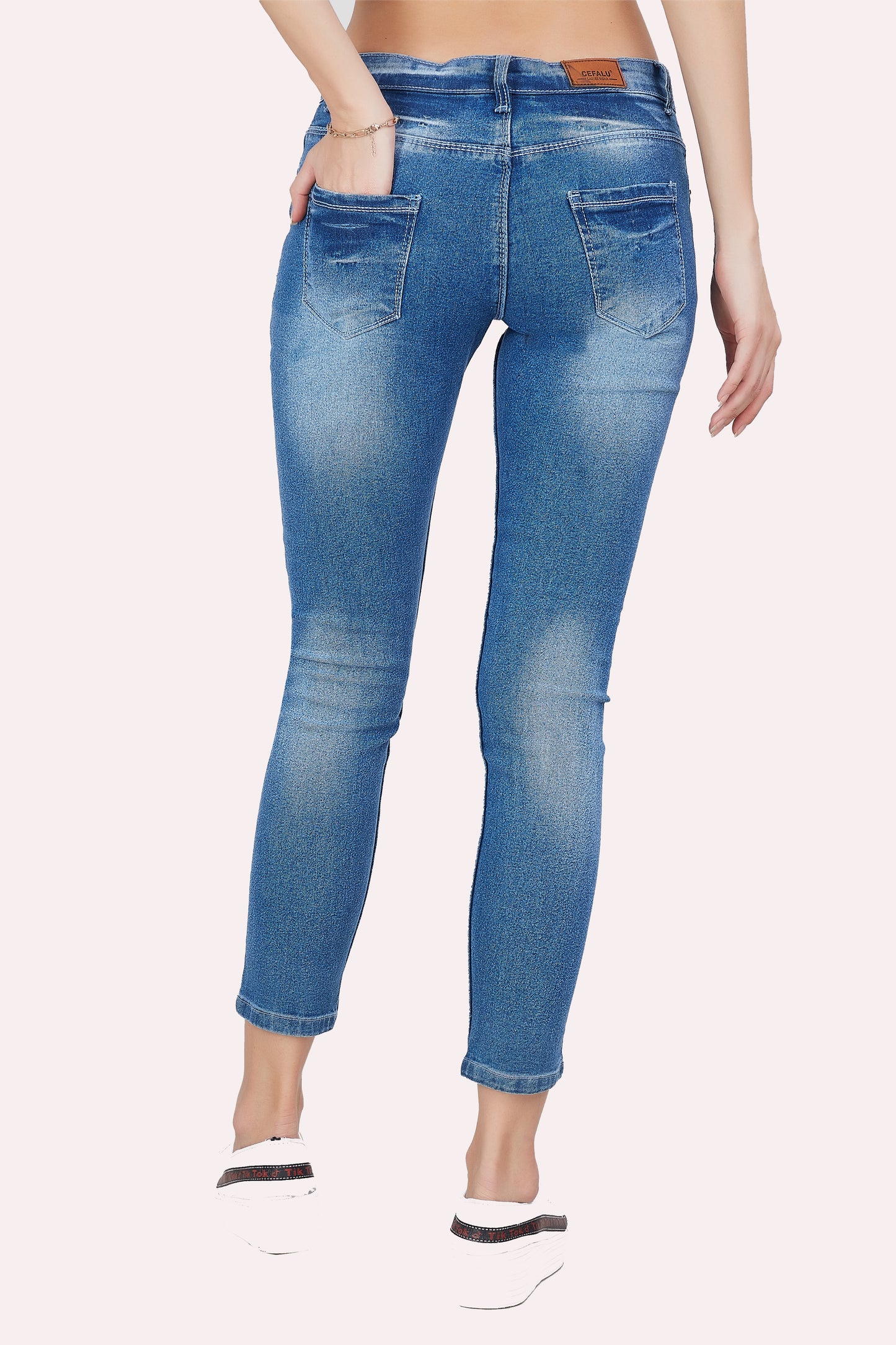 Back view of Cefalu®️ Women’s Light Blue Slim Fit Jeans, featuring the mid-rise fit and overall design.