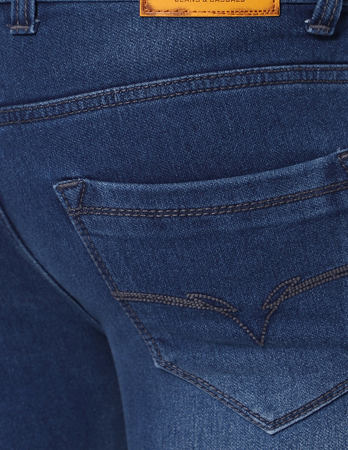 Close-up of the back pocket on TCI Men’s Dark Blue Jeans, focusing on the stitching and design details.