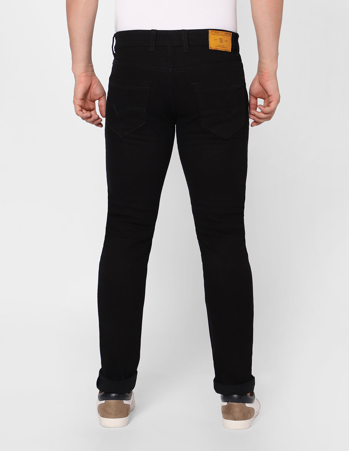 Back view of TCI Men's Regular Fit Stretchable Black Denim Jeans, highlighting the fit and pocket details.