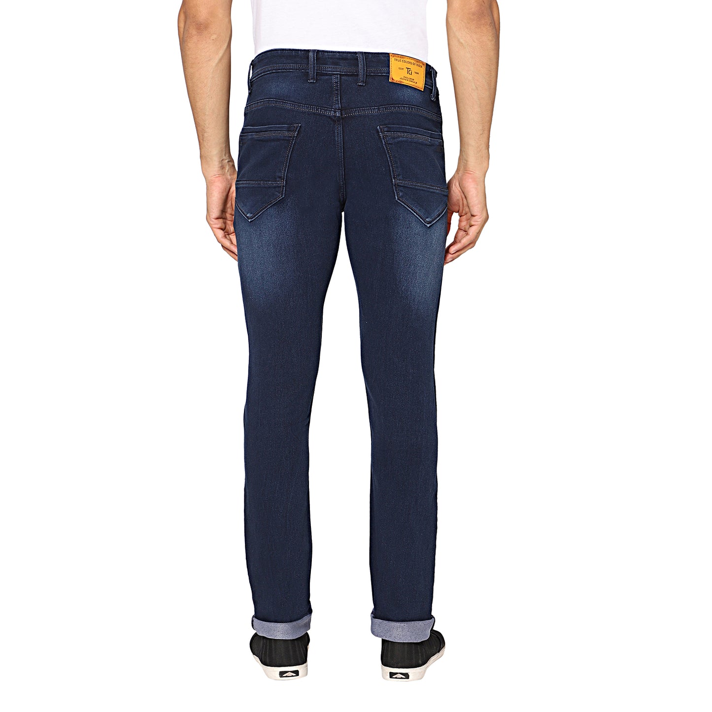 Back view of TCI Men’s Dark Blue Stretchable Jeans, highlighting the functional back pockets and the regular fit. The jeans have a subtly distressed finish for a trendy appearance.