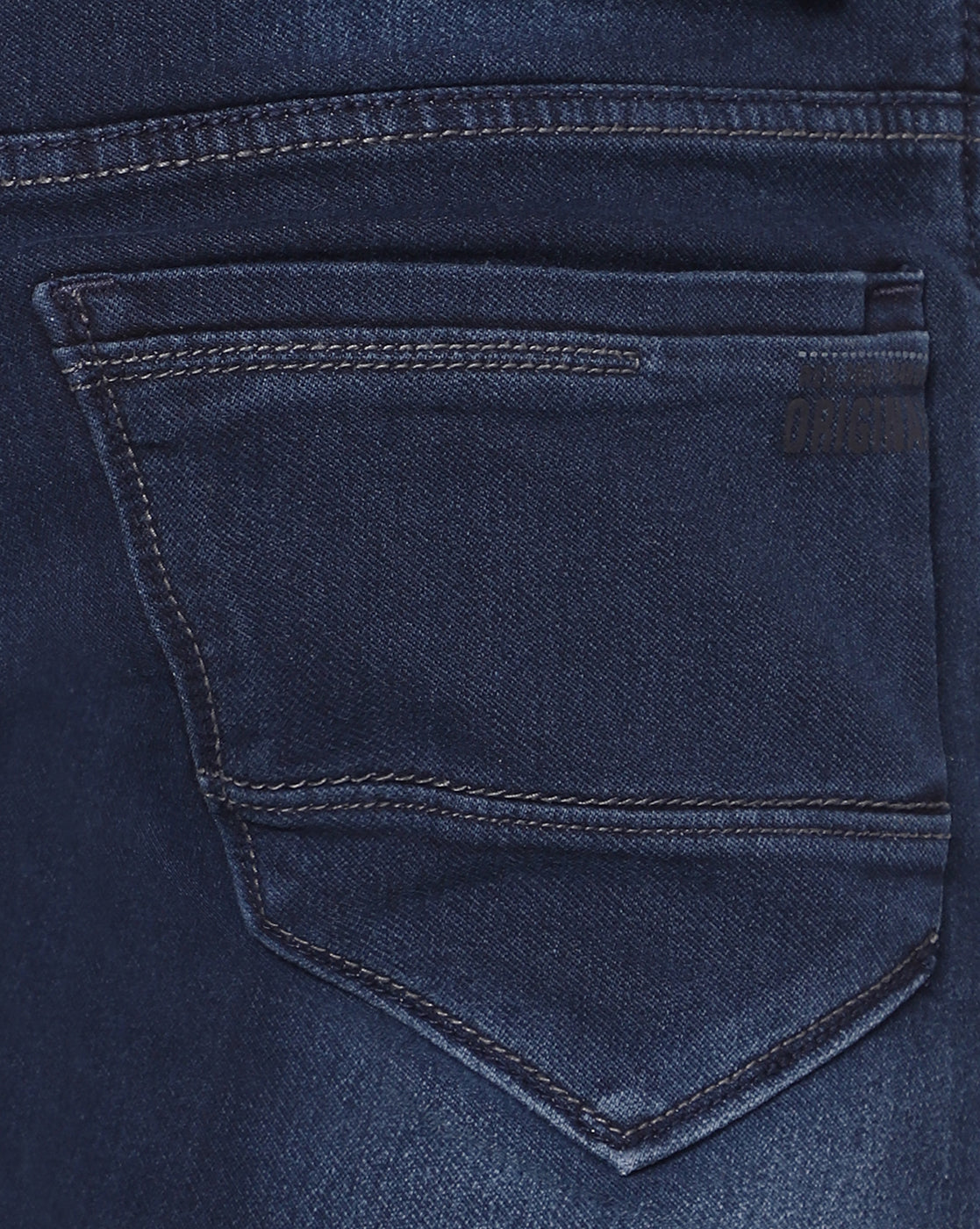 Close-up of TCI Men’s Dark Blue Stretchable Jeans, showing the texture of the premium cotton-poly fabric and the mild distressing details. The stretchable material offers both durability and comfort.