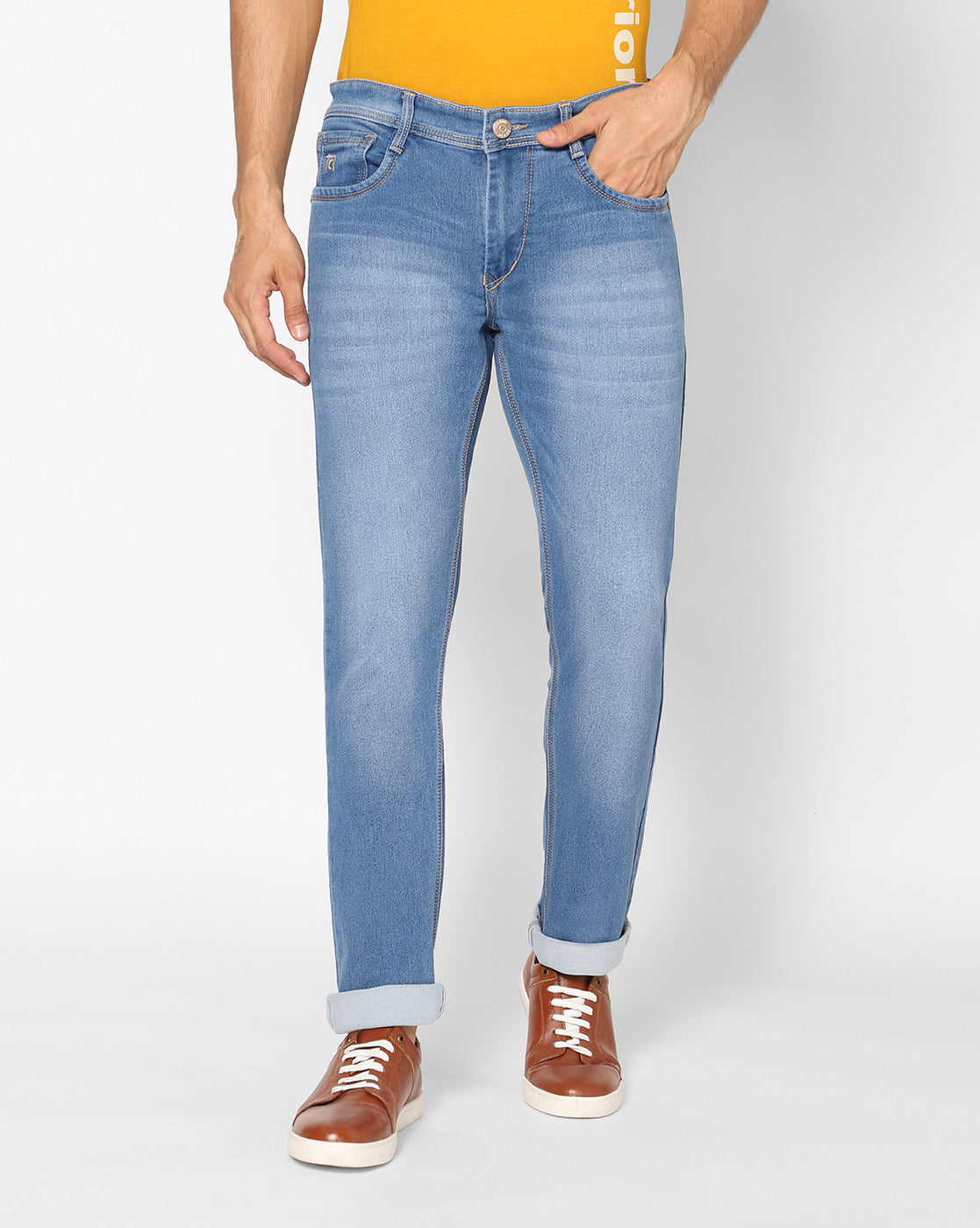 Front view of TCI Men’s Light Blue Stretchable Jeans, featuring a regular fit and mild distressing. The jeans are made from a cotton-poly blend for comfort and durability.