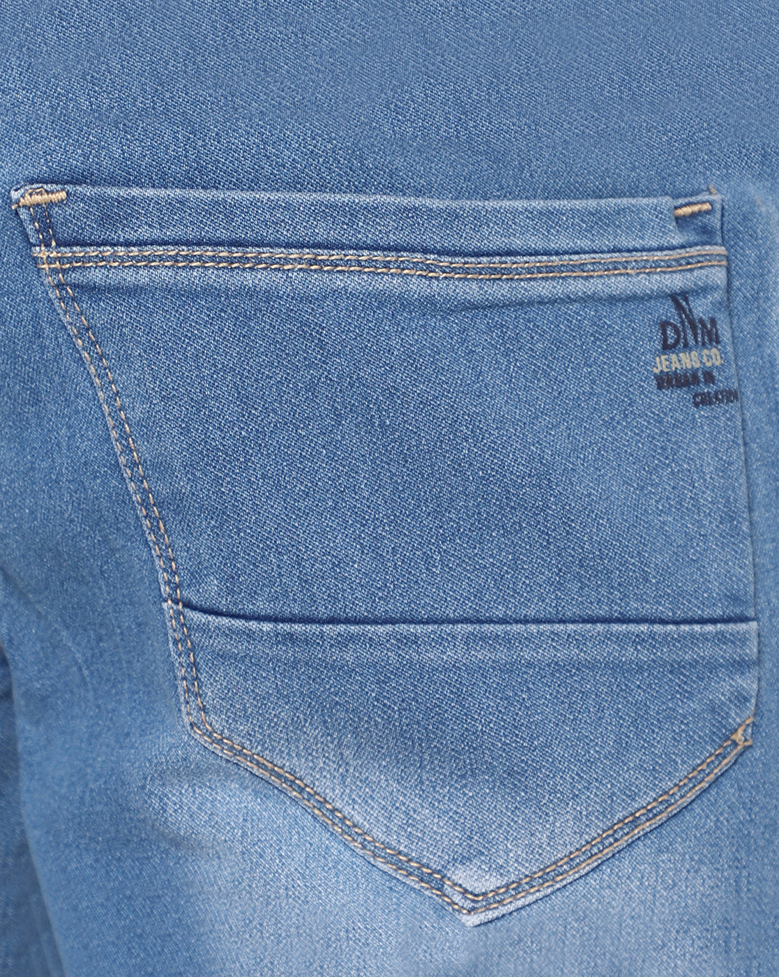 Close-up of the fabric of TCI Men’s Light Blue Stretchable Jeans, highlighting the cotton-poly mix and mild distressing. The material is stretchable for added comfort and flexibility.