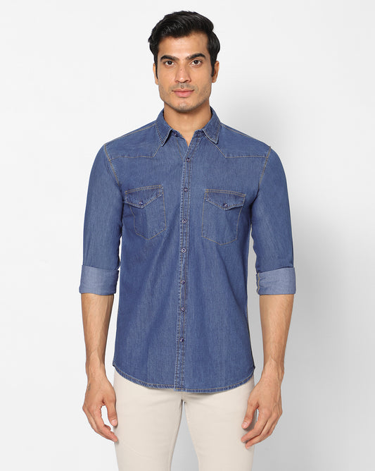 Front view of TCI Men’s Mid Blue Cotton Denim Shirt showing the classic button-front design, spread collar, and stylish chest pockets with button fastenings.