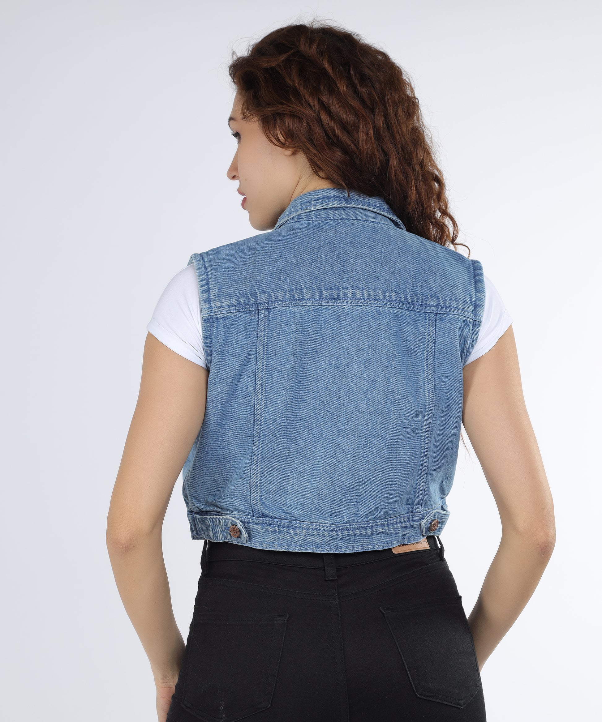 Back view of the Cefalu Women’s Light Blue Denim Jacket, highlighting its sleek fit.