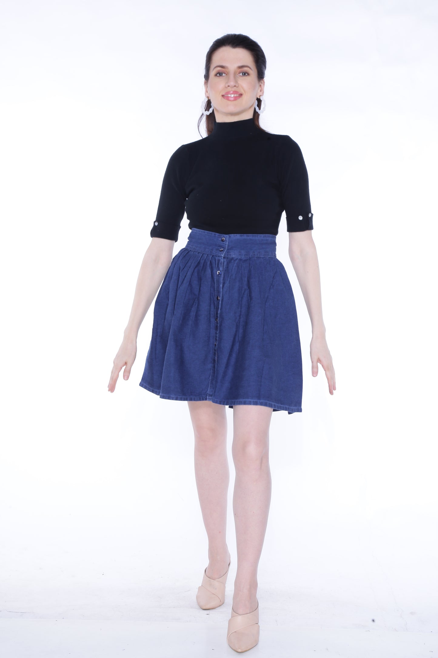 Full-length view of a model wearing Cefalu®️ Women’s Dark Blue Denim Mini Skirt, demonstrating its flattering fit and playful design.