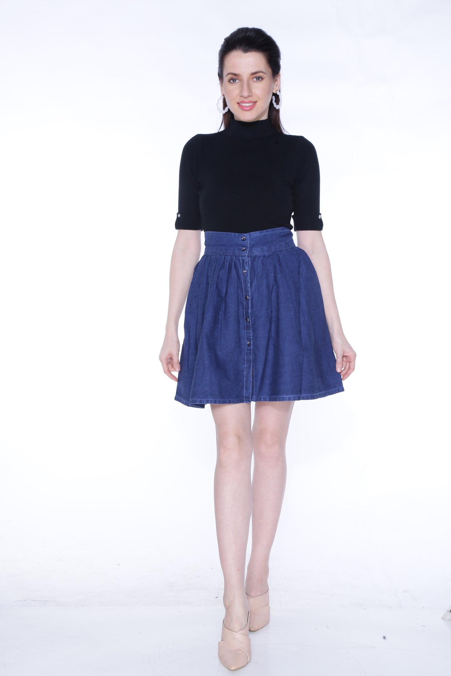 Full-length view of a model wearing Cefalu®️ Women’s Dark Blue Denim Mini Skirt, demonstrating its flattering fit and playful design.