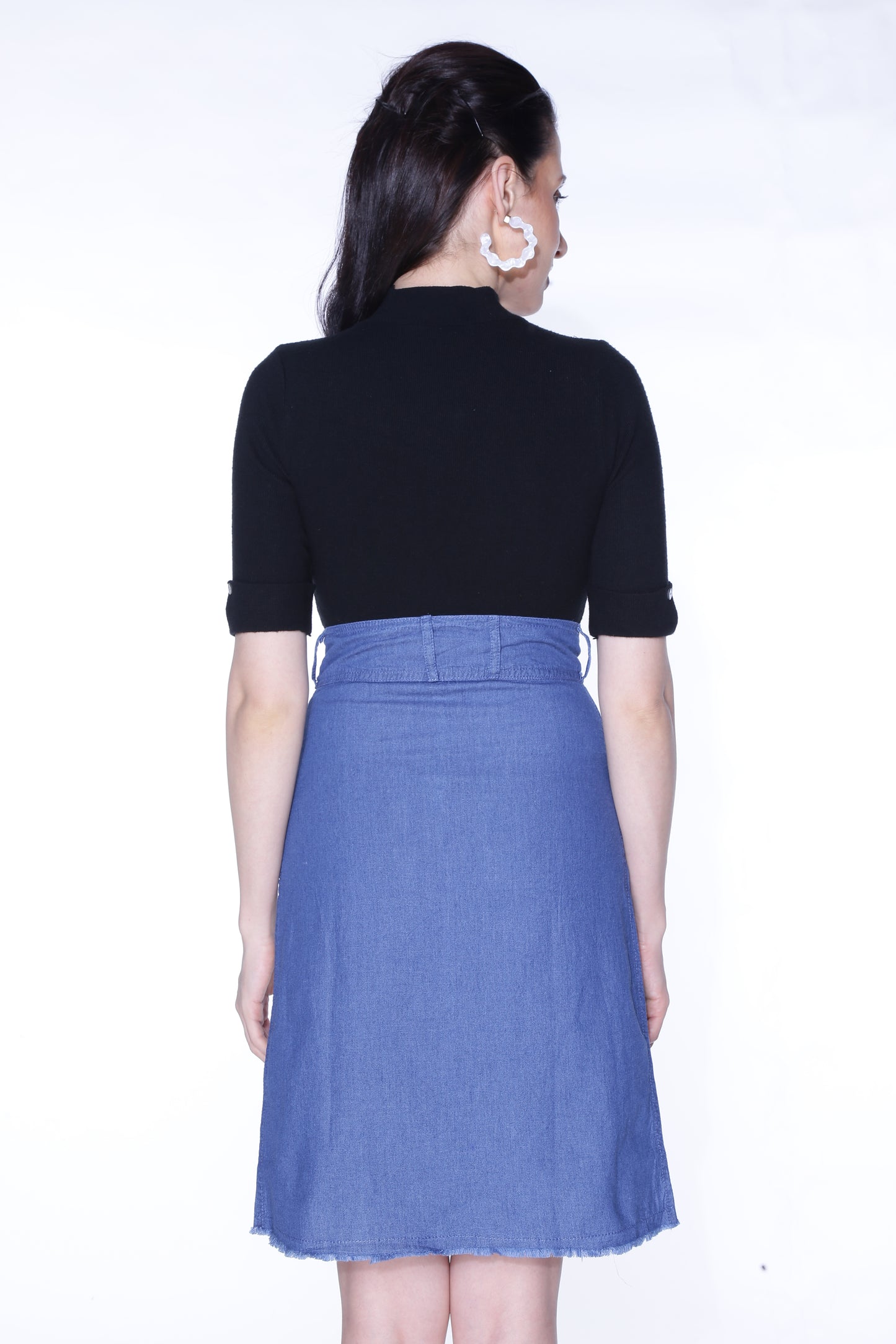 Back view of Cefalu®️ Women’s Blue Denim Mini Skirt, highlighting the classic blue denim and two practical pockets.