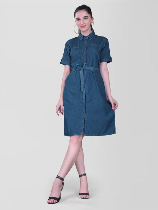 Front view of Cefalu Women’s Blue Denim Dress showcasing a solid A-line midi design with a shirt collar and half sleeves with luppi. The dress features two side pockets and is styled in soft blue denim fabric.