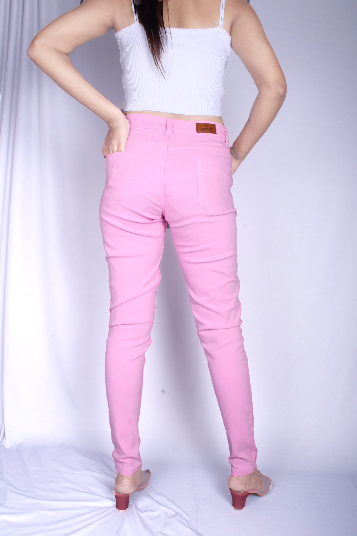 Back view of Cefalu®️ Women’s Pink Slim Fit Jeans, featuring the comfortable back pockets and mid-rise fit.