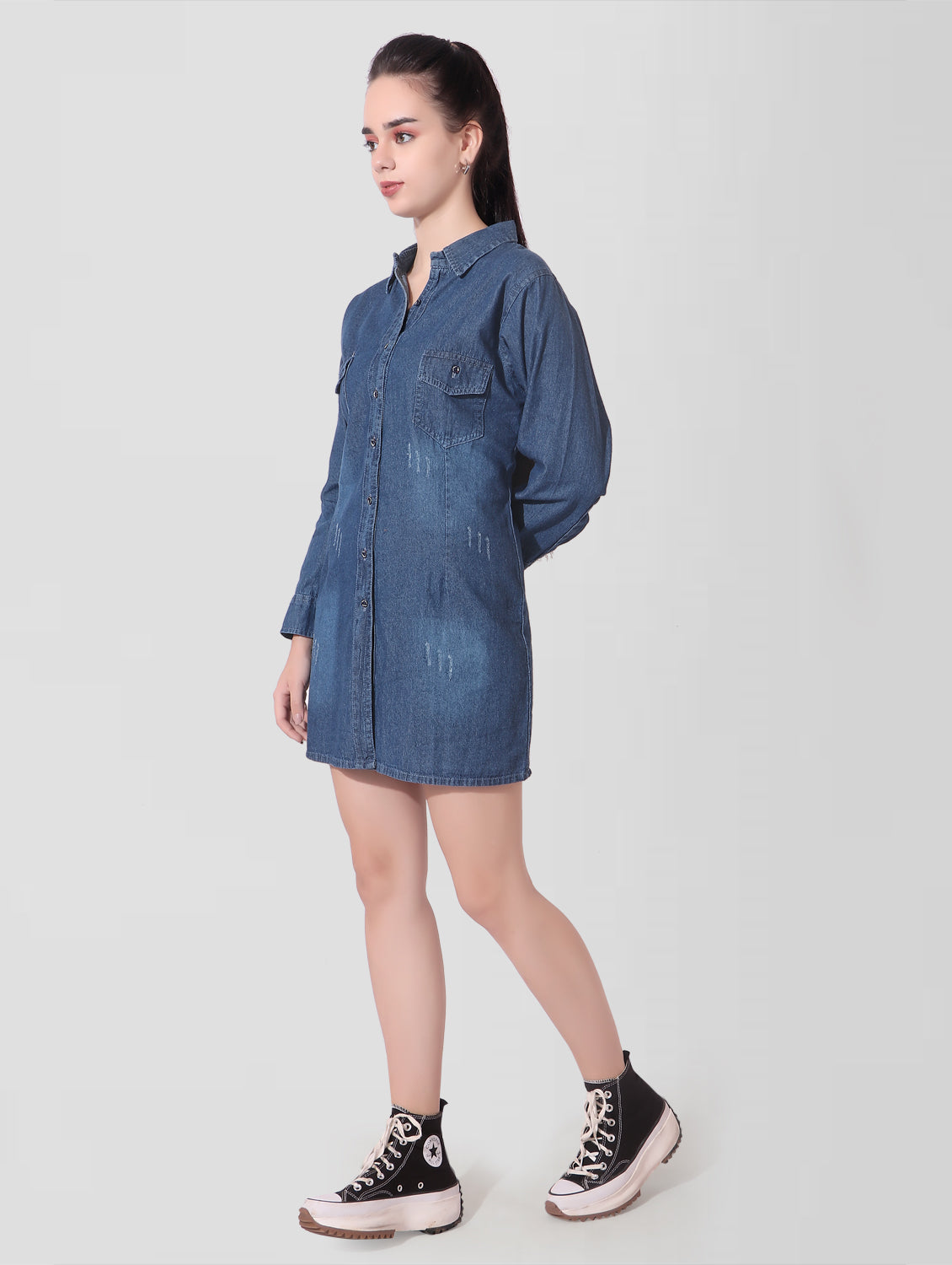 Side view of Women’s Blue Denim Shirt Dress demonstrating the above-knee length and elegant, full sleeve design.