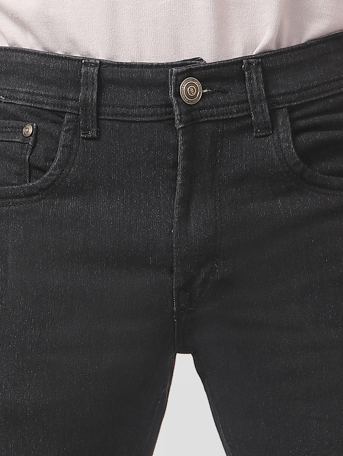 Close-up of TCI Men’s Black Slim Fit Jeans waistband, featuring belt loops and zip fly with button closure.