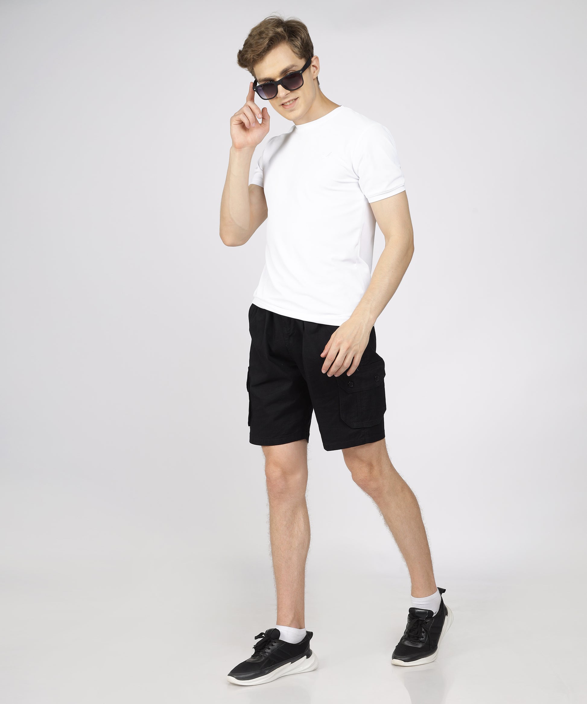 Model showcasing TCI Men’s Black Twill Cargo Bermuda Shorts styled for a casual outing.