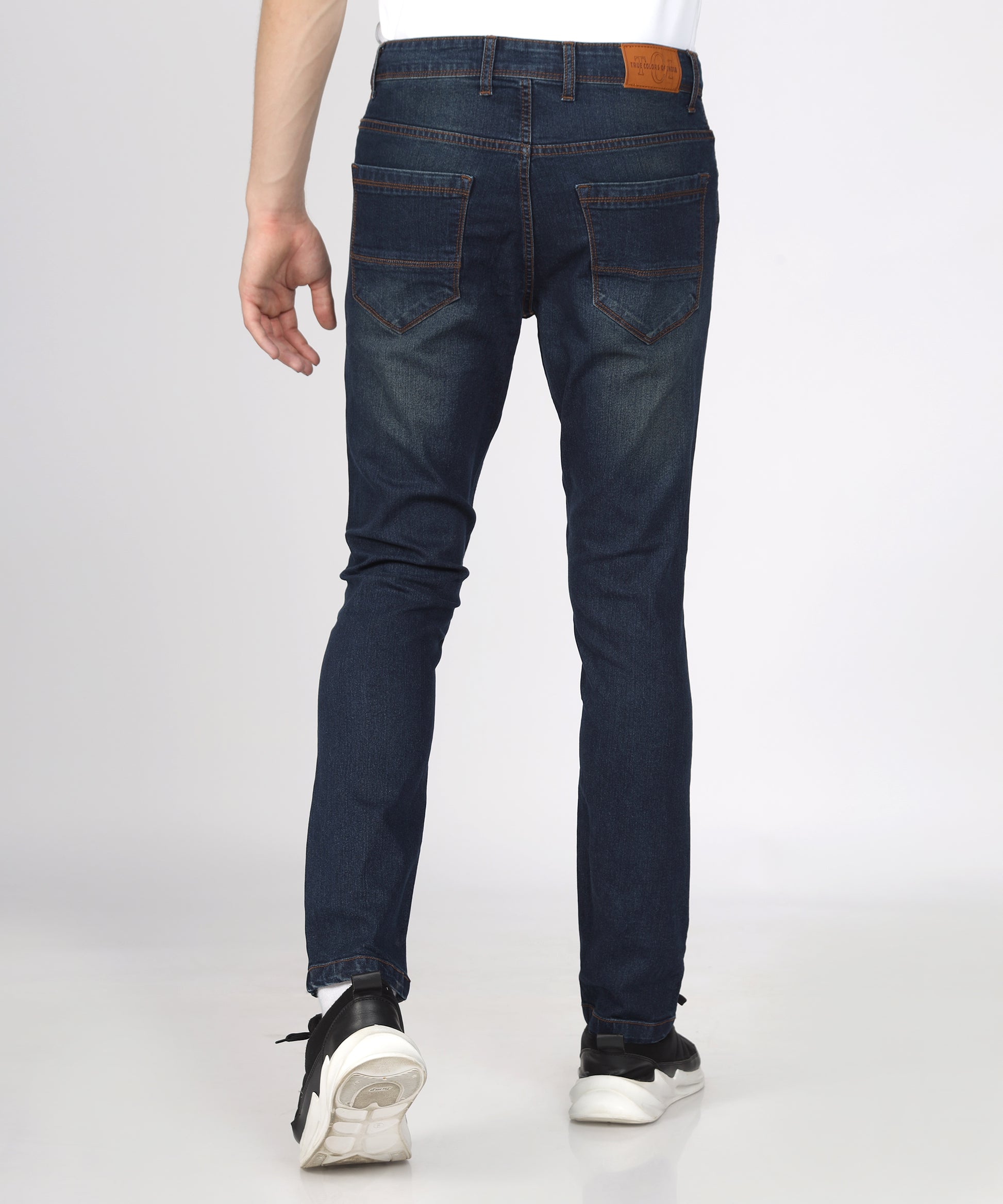 Fabric texture of TCI Men’s Corbon Blue Slim Fit Jeans highlighting stretchability.